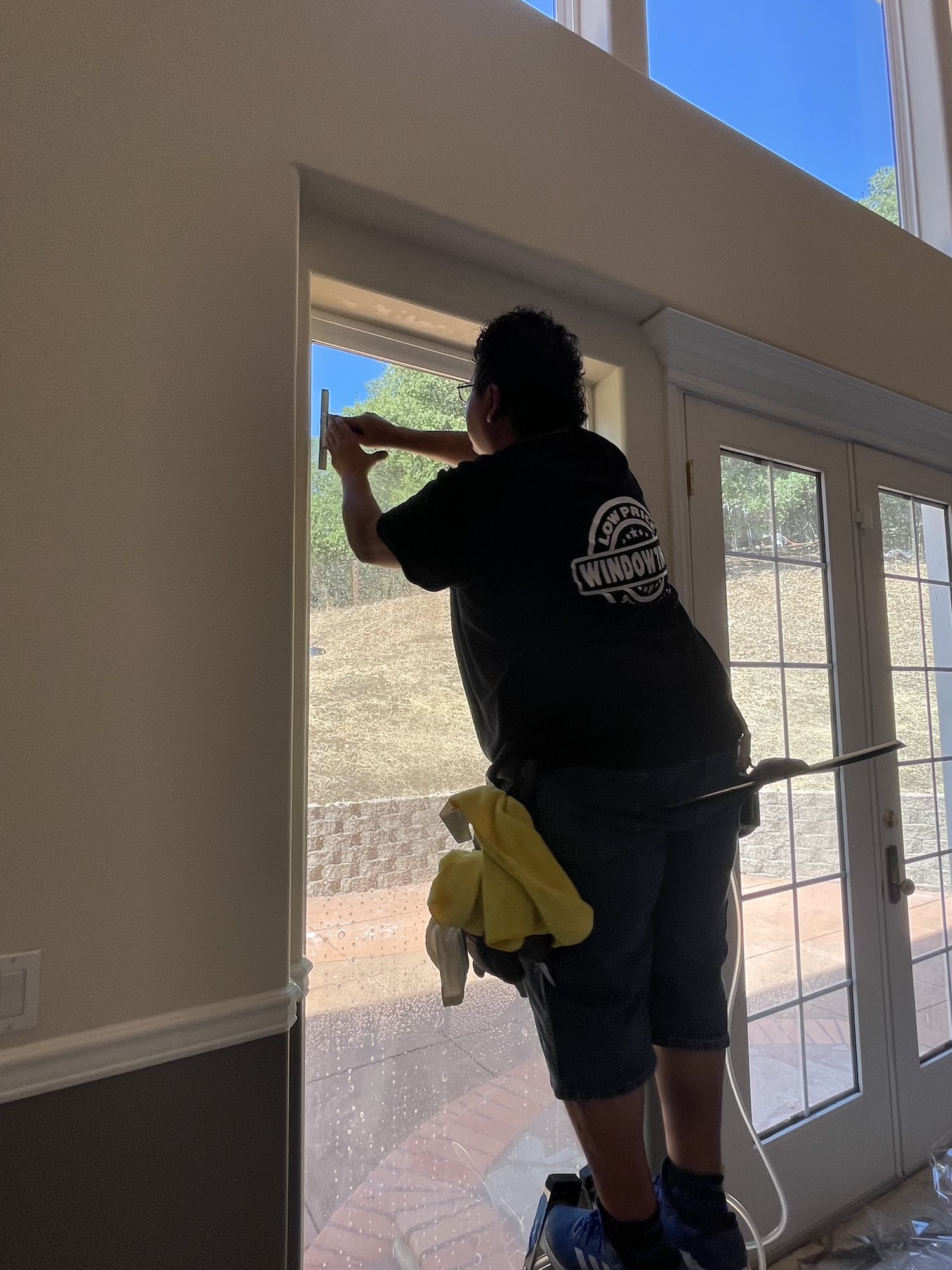 Certified Low Price Window Tint installer applying Solar Gard film to a French door in a Dublin, CA home